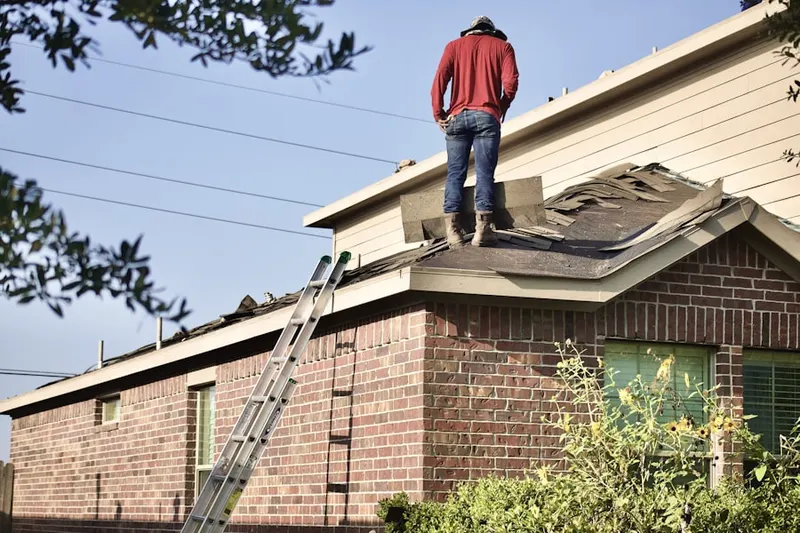 Professional roofer working on a residential roof in Pumpkin Center